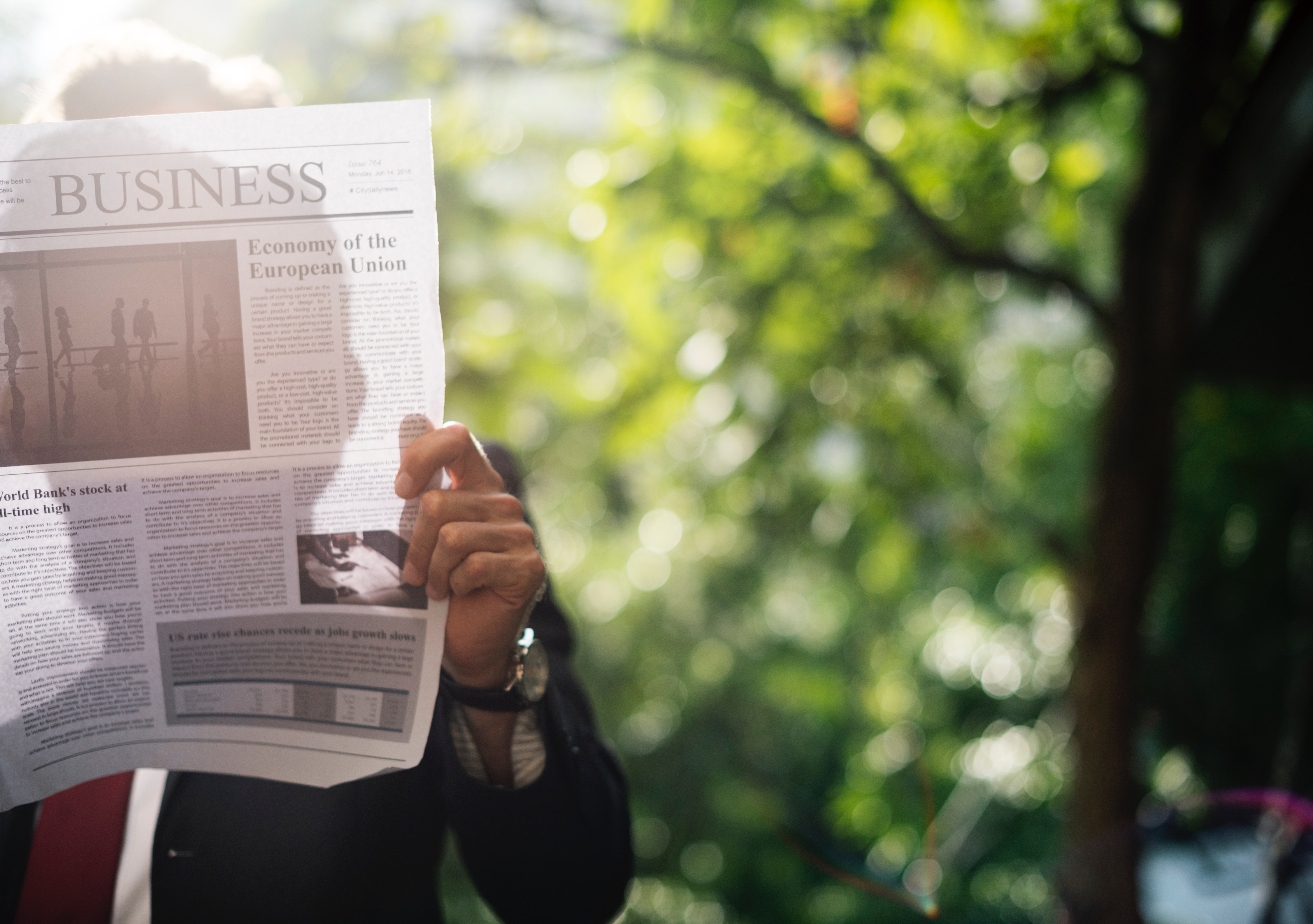 Man reading a newspaper. Utilize news articles in your Business English Course